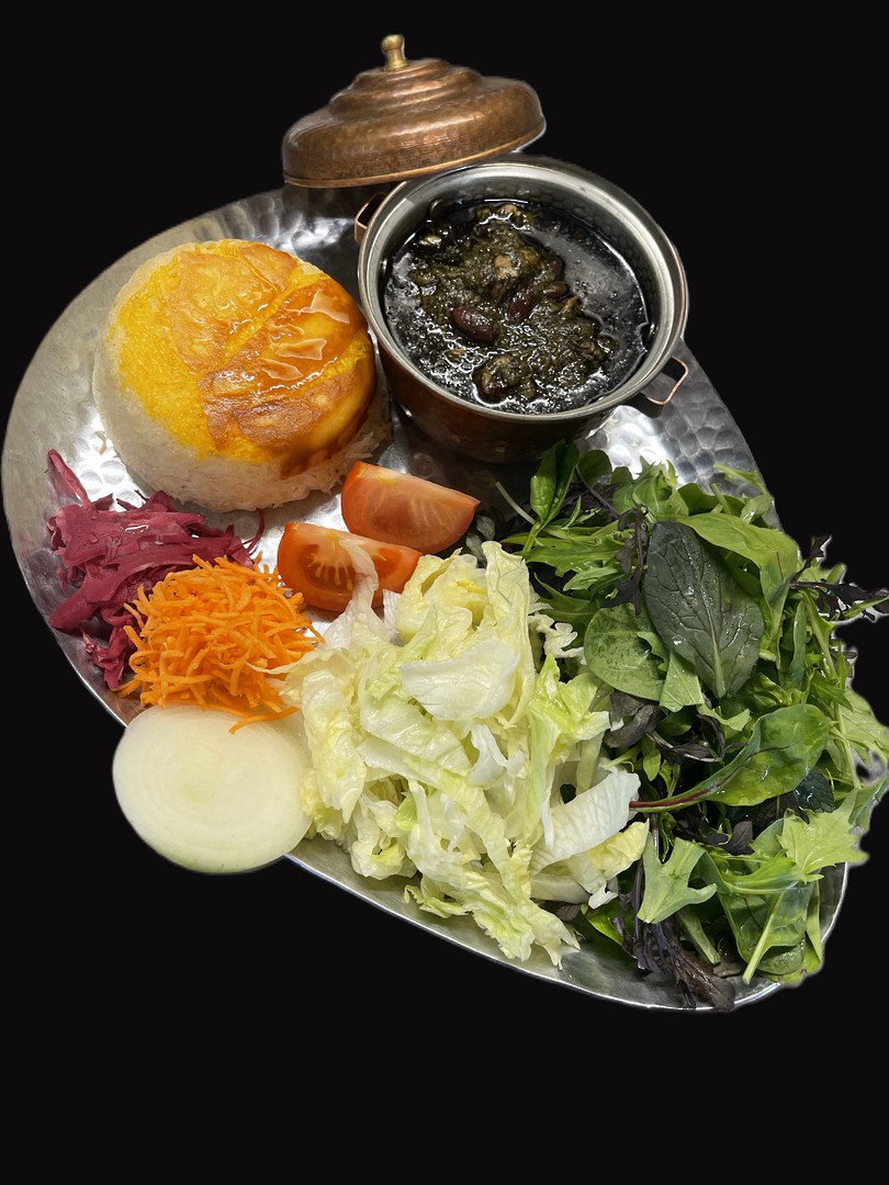 Ghormeh Sabzi — a copper-lidded pot of green herb-and-kidney-bean lamb stew with a saffron-rice dome and fresh salad